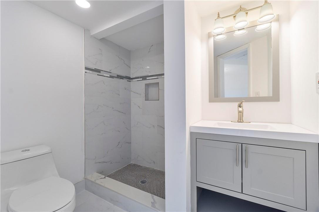 8025 South Colony Circle, Unit 106 Tamarac, FL 33321 - Photo 7 of 14 a bathroom with a sink a toilet and shower