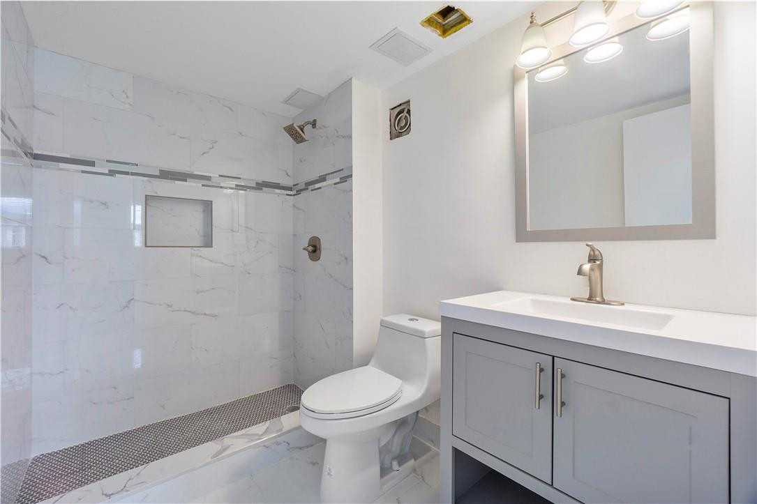 8025 South Colony Circle, Unit 106 Tamarac, FL 33321 - Photo 9 of 14 a bathroom with a sink a toilet and shower