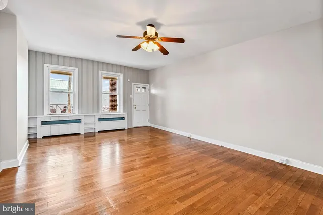 wooden floor in an empty room with a window