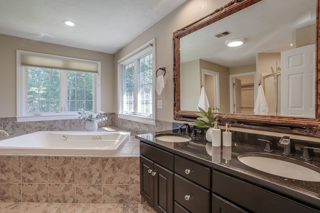 35 Buehler Road Bedford, MA 01730 - Photo 20 of 41 a spacious bathroom with a tub double sink and mirror