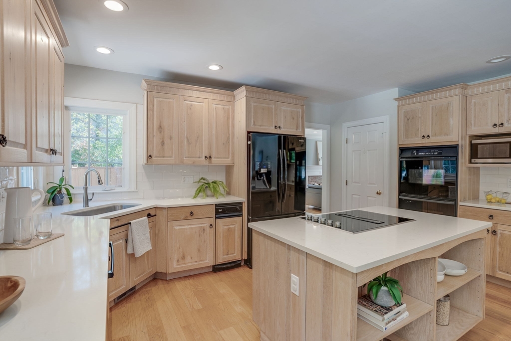 35 Buehler Road Bedford, MA 01730 - Photo 2 of 41 a kitchen with stainless steel appliances a sink a stove a refrigerator cabinets and a window