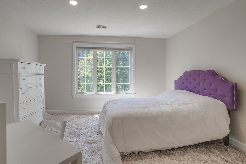35 Buehler Road Bedford, MA 01730 - Photo 21 of 41 a large bed sitting in a bedroom next to a window