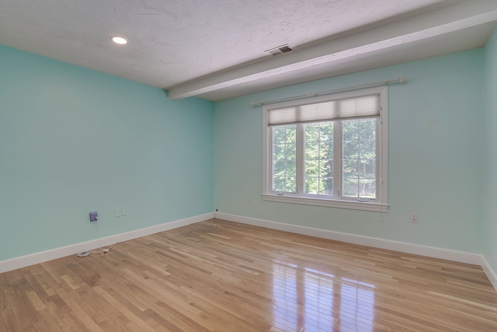 35 Buehler Road Bedford, MA 01730 - Photo 23 of 41 an empty room with wooden floor and windows