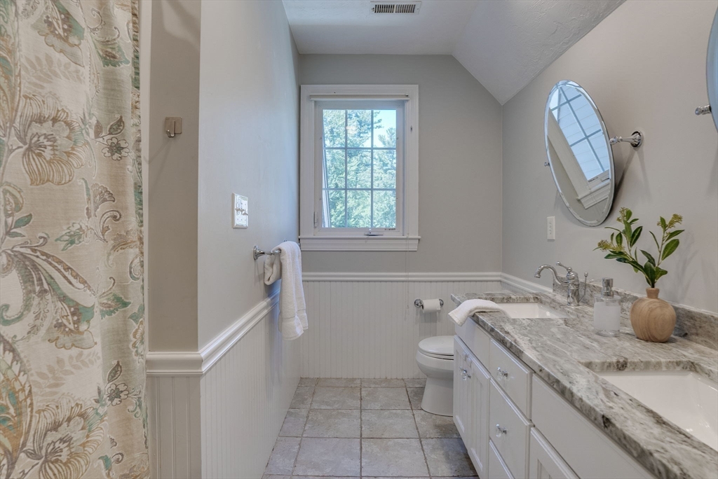 35 Buehler Road Bedford, MA 01730 - Photo 24 of 41 a bathroom with a granite countertop sink a toilet and with mirror