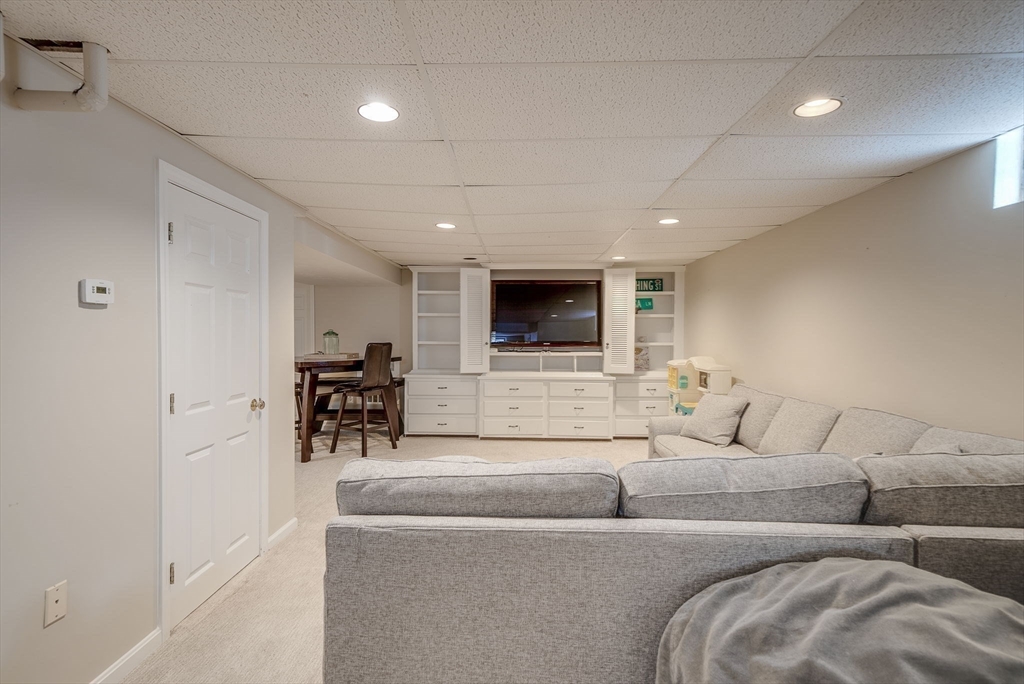 35 Buehler Road Bedford, MA 01730 - Photo 27 of 41 a living room with furniture and a flat screen tv