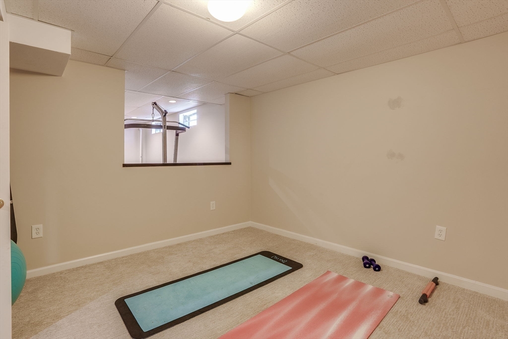 35 Buehler Road Bedford, MA 01730 - Photo 30 of 41 a room with a hanging light and a lamp