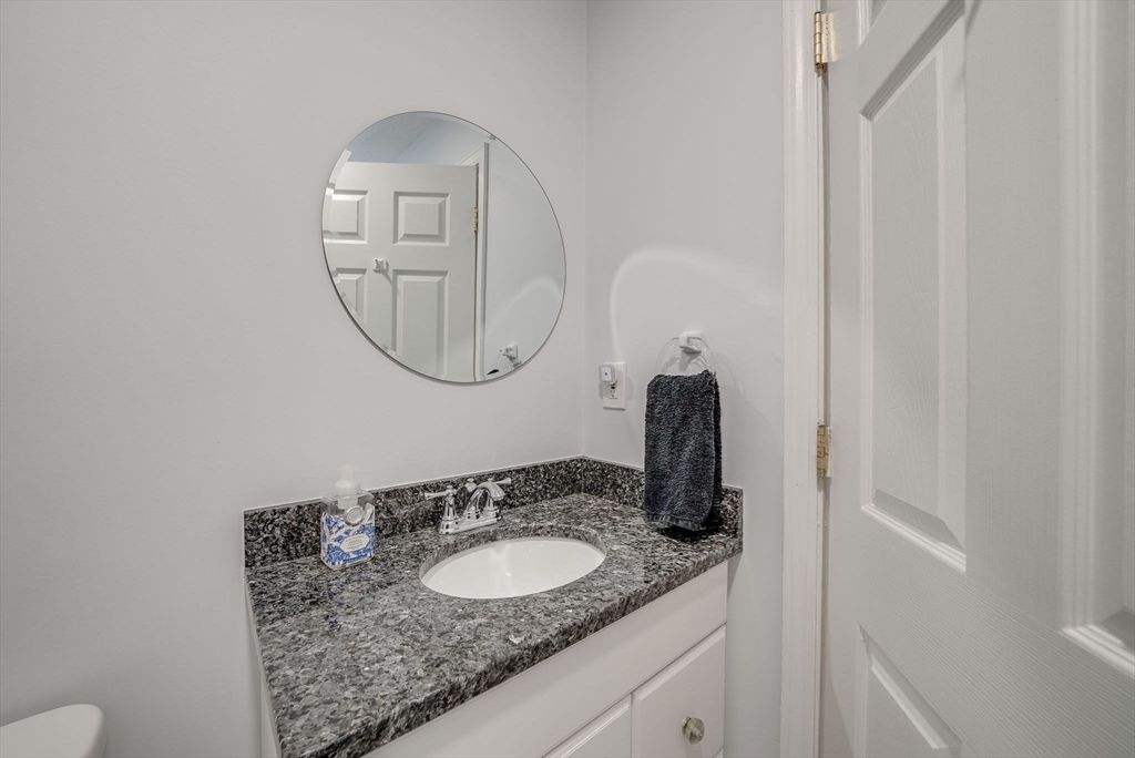 35 Buehler Road Bedford, MA 01730 - Photo 31 of 41 a bathroom with a granite countertop sink and a mirror