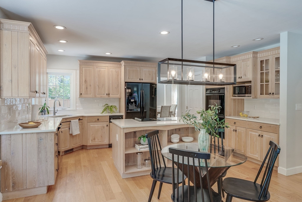 35 Buehler Road Bedford, MA 01730 - Photo 4 of 41 a kitchen with kitchen island a large counter top space appliances and cabinets