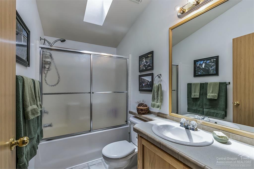 17171 Island Loop Way Bend, OR 97707 - Photo 12 of 25 a bathroom with a sink toilet and shower