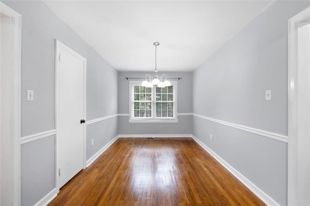 111 Poplar Street Fairburn, GA 30213 - Photo 11 of 32 a view of wooden floor in an empty room with a window