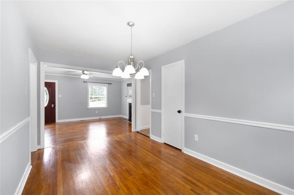 111 Poplar Street Fairburn, GA 30213 - Photo 12 of 32 a view of a livingroom with a chandelier fan and windows