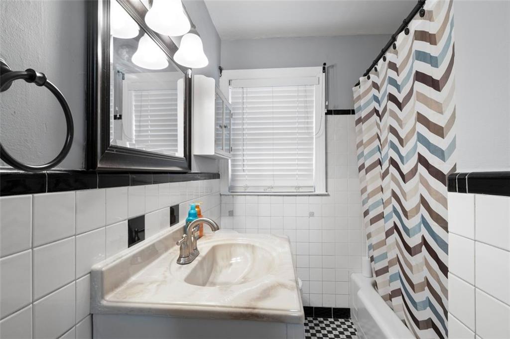 111 Poplar Street Fairburn, GA 30213 - Photo 13 of 32 a bathroom with a sink and a mirror
