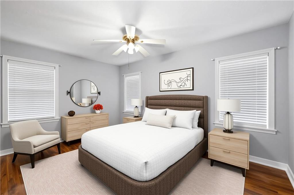 111 Poplar Street Fairburn, GA 30213 - Photo 14 of 32 a bedroom with a large bed and a chandelier