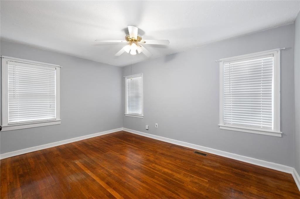 111 Poplar Street Fairburn, GA 30213 - Photo 15 of 32 a view of an empty room with wooden floor and a window