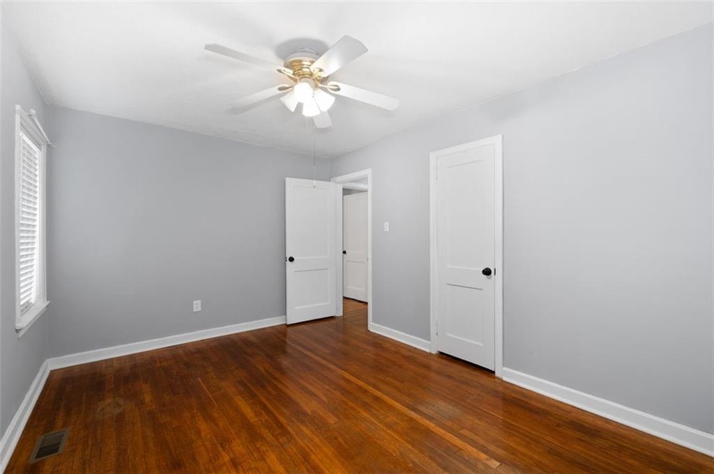 111 Poplar Street Fairburn, GA 30213 - Photo 16 of 32 a view of an empty room with wooden floor
