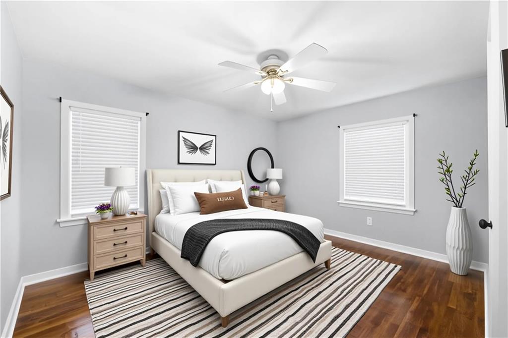 111 Poplar Street Fairburn, GA 30213 - Photo 17 of 32 a bedroom with a bed a dresser and wooden floor