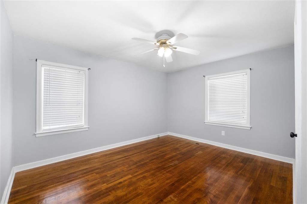 111 Poplar Street Fairburn, GA 30213 - Photo 18 of 32 a view of empty room with wooden floor and fan