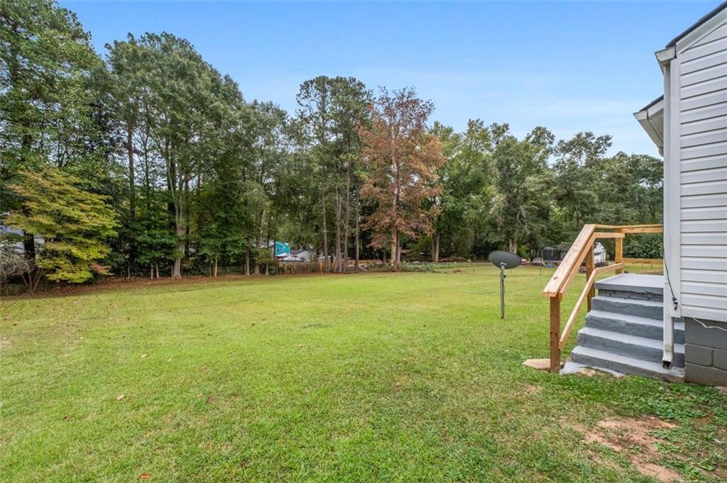 111 Poplar Street Fairburn, GA 30213 - Photo 27 of 32 a view of a garden with a slide