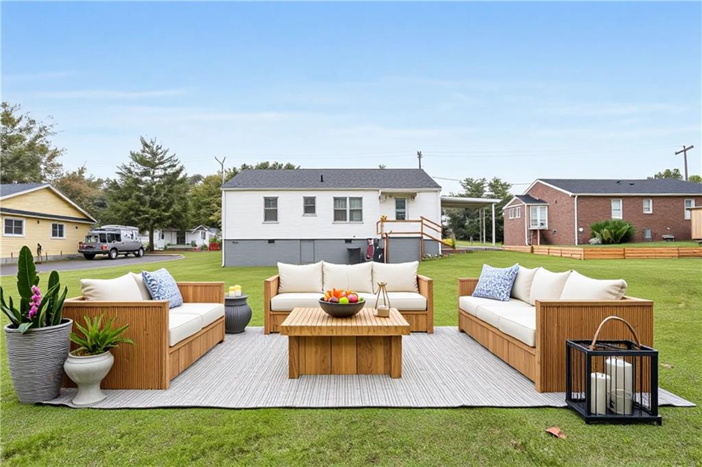 111 Poplar Street Fairburn, GA 30213 - Photo 29 of 32 a view of a patio with couches and a table and chairs with garden view