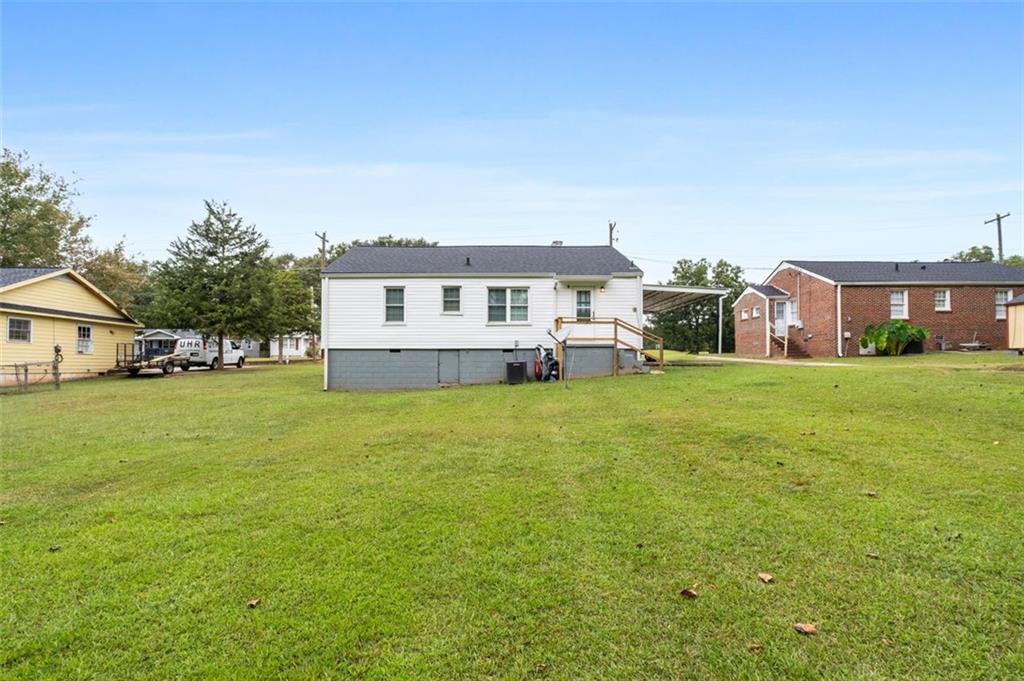 111 Poplar Street Fairburn, GA 30213 - Photo 30 of 32 a front view of a house with a garden and trees