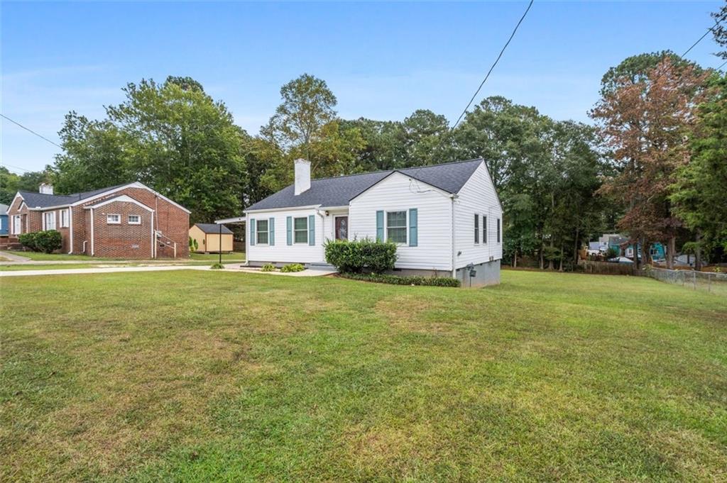 111 Poplar Street Fairburn, GA 30213 - Photo 3 of 32 a front view of a house with garden