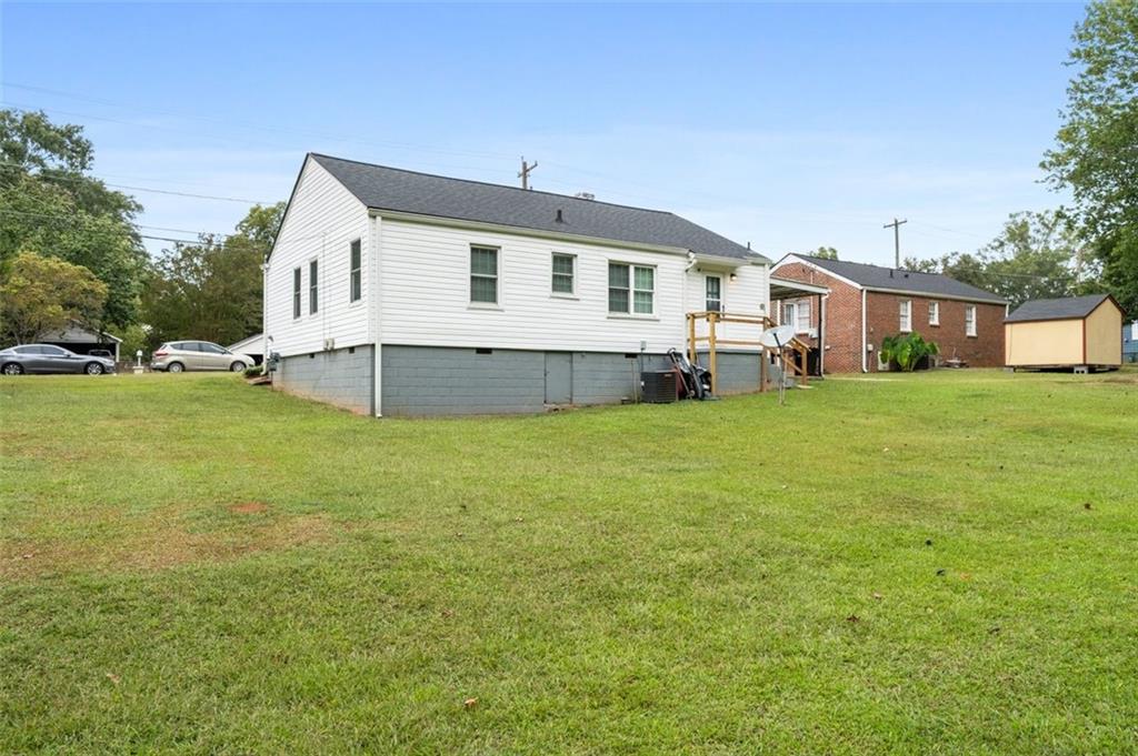 111 Poplar Street Fairburn, GA 30213 - Photo 31 of 32 a front view of a house with a garden and yard