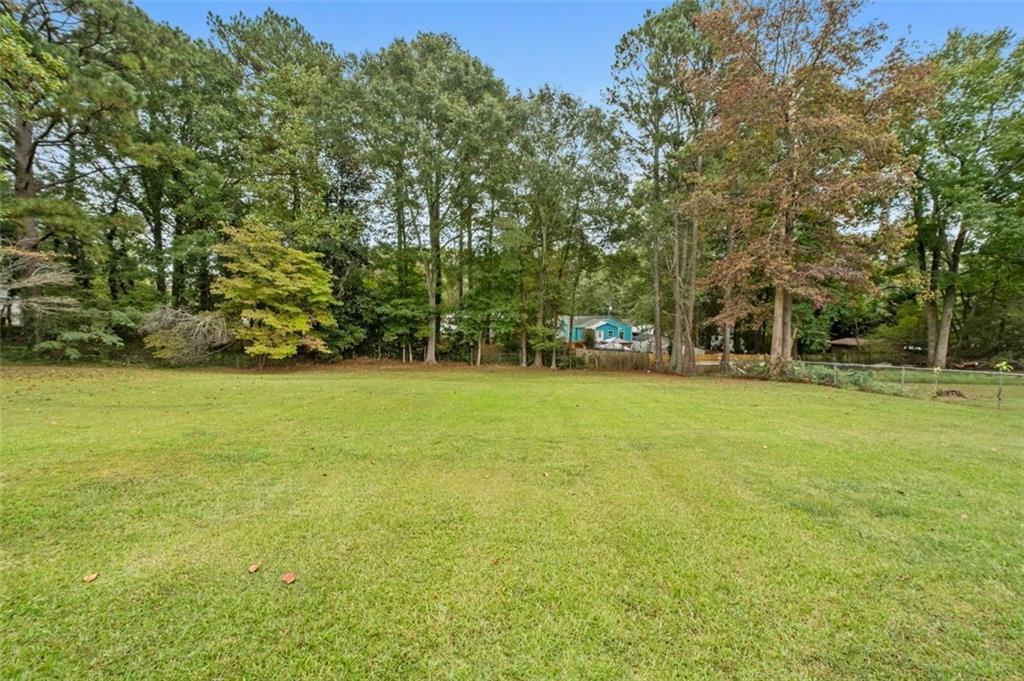 111 Poplar Street Fairburn, GA 30213 - Photo 32 of 32 a view of yard with green space and trees
