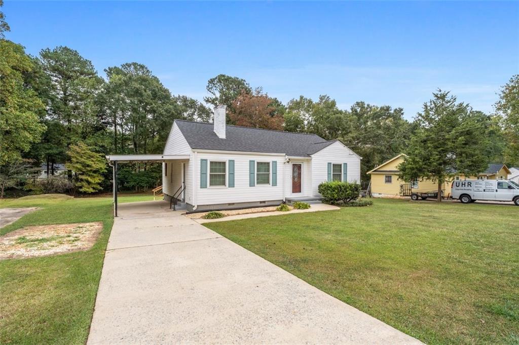 111 Poplar Street Fairburn, GA 30213 - Photo 4 of 32 a front view of a house with garden
