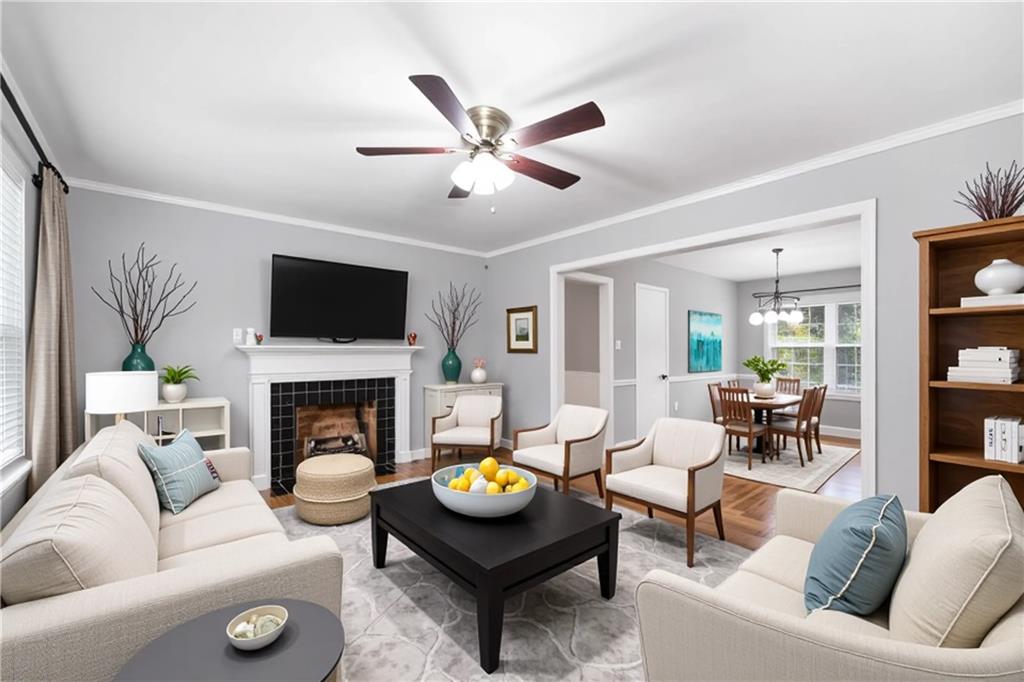 111 Poplar Street Fairburn, GA 30213 - Photo 6 of 32 a living room with furniture a fireplace and a flat screen tv