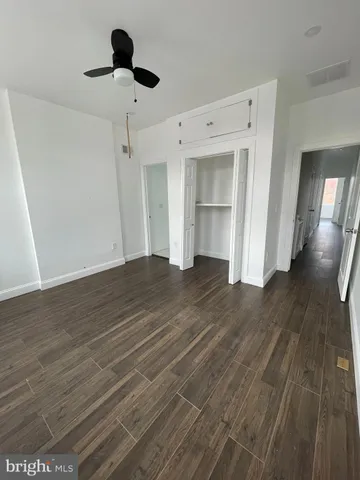 a view of a room with wooden floor