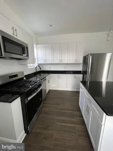 a kitchen with stainless steel appliances wooden cabinets and granite counter tops