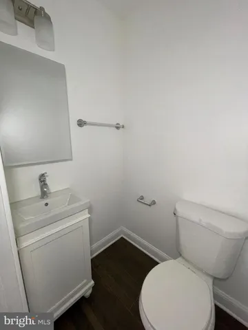 a white toilet sitting next to a bathroom sink
