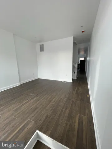 a view of a room with wooden floor