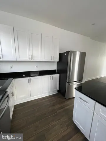 a kitchen with a refrigerator and a stove