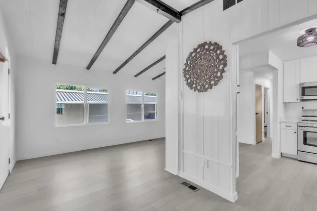 a kitchen with stainless steel appliances a refrigerator sink and microwave