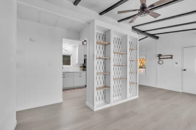 a view of a hallway with wooden floor