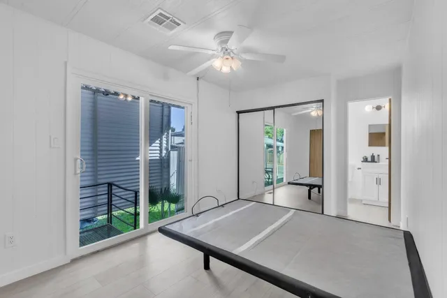 a view of a room with a ceiling fan and a rug