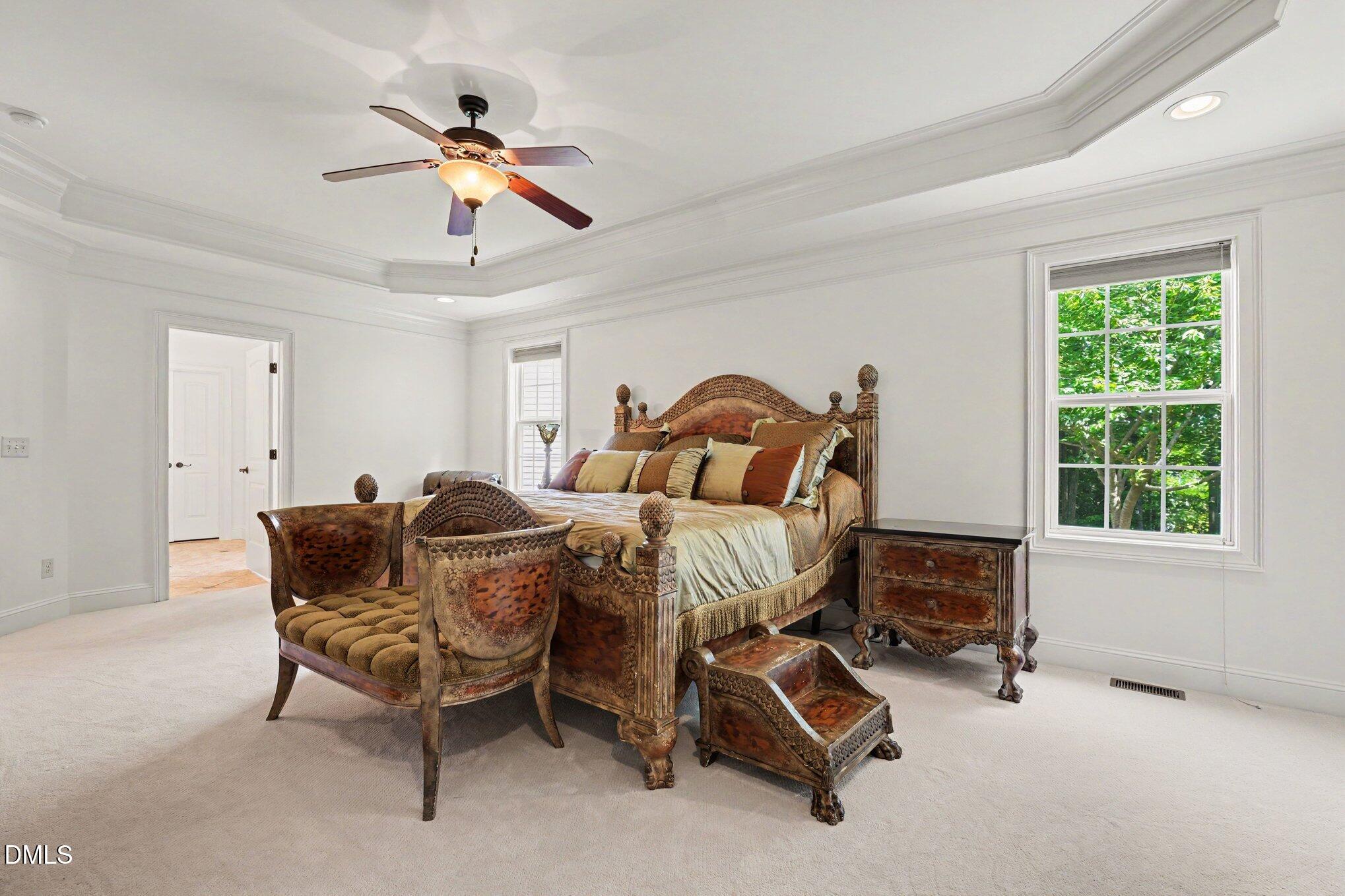 1729 Frenchwood Drive Raleigh, NC 27612 - Photo 12 of 46 a bedroom with a bed and a chandelier
