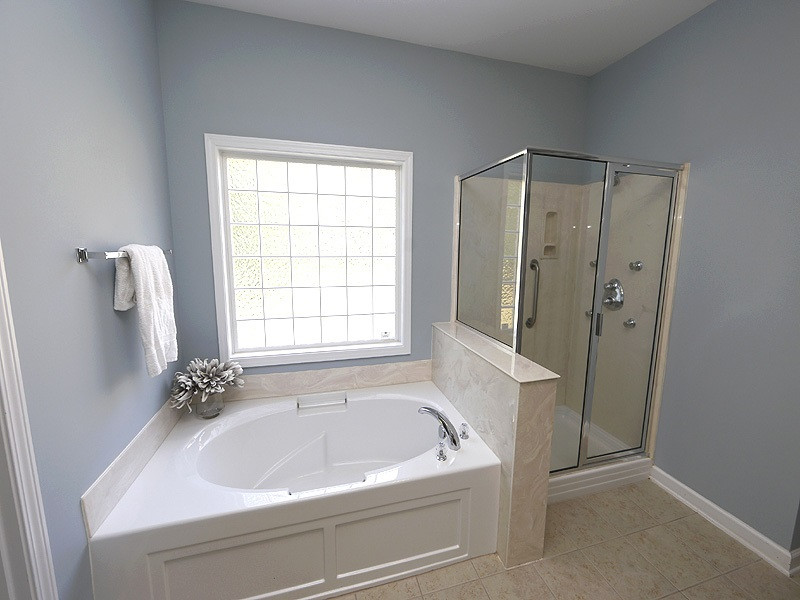 3324 Queensland Road Raleigh, NC 27614 - Photo 14 of 25 The master bath has a large garden tub and walk-in shower. There is a separate commode room and an extra long vanity. The master closet is huge. Master Bath