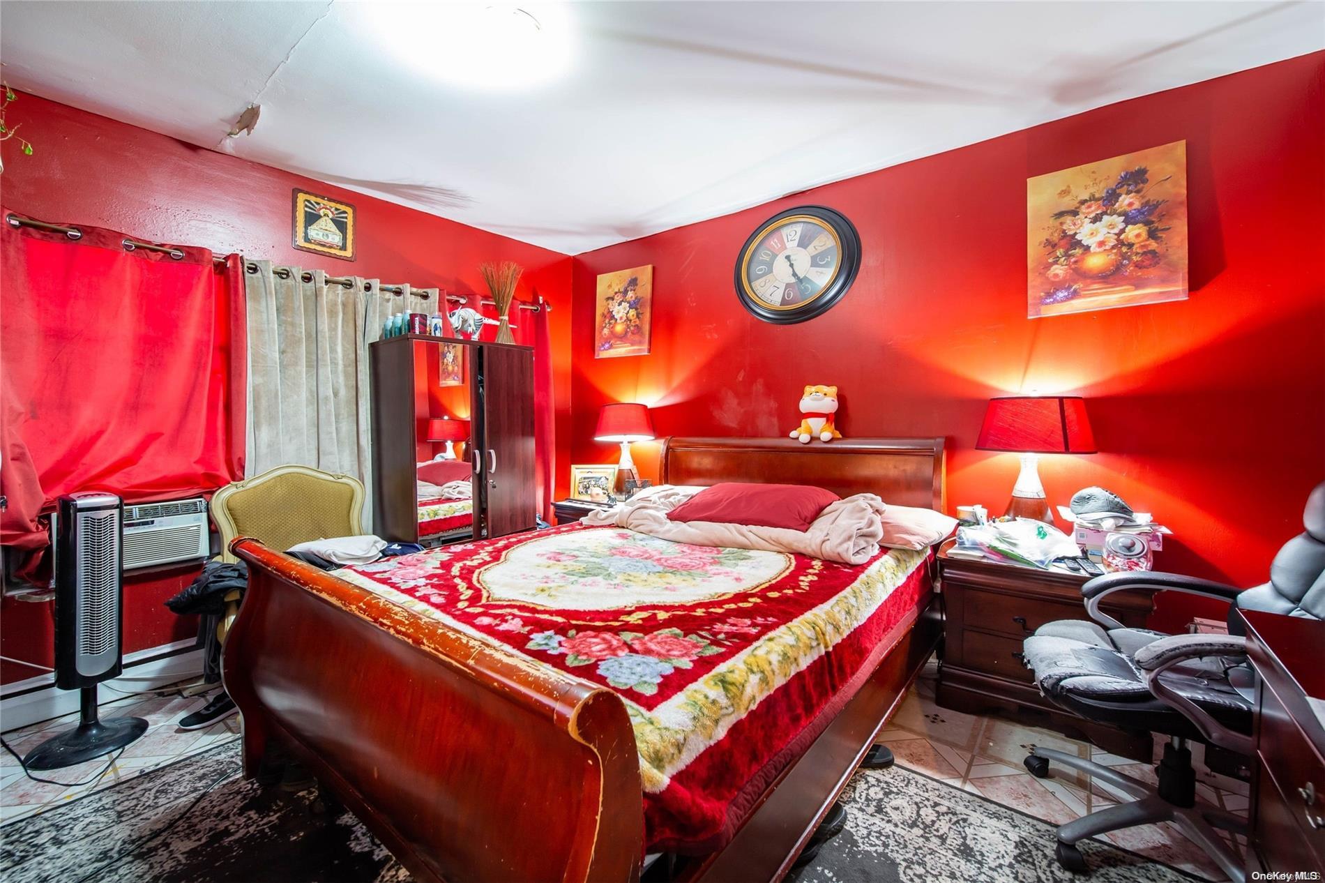 102-18 37th Avenue Queens, NY 11368 - Photo 6 of 12 a bed room with a bed and a table