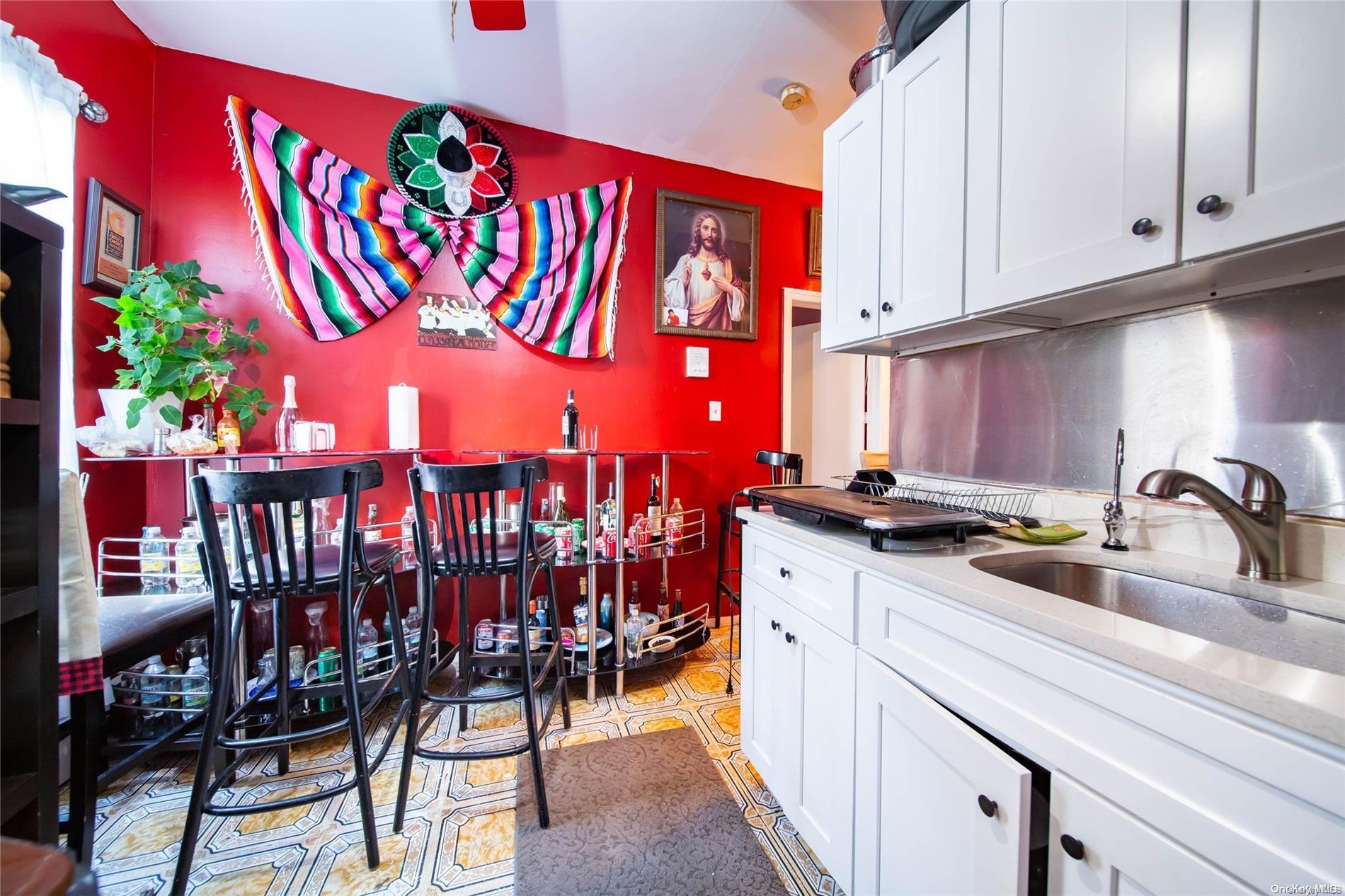 102-18 37th Avenue Queens, NY 11368 - Photo 9 of 12 a kitchen with stainless steel appliances granite countertop a sink and cabinets
