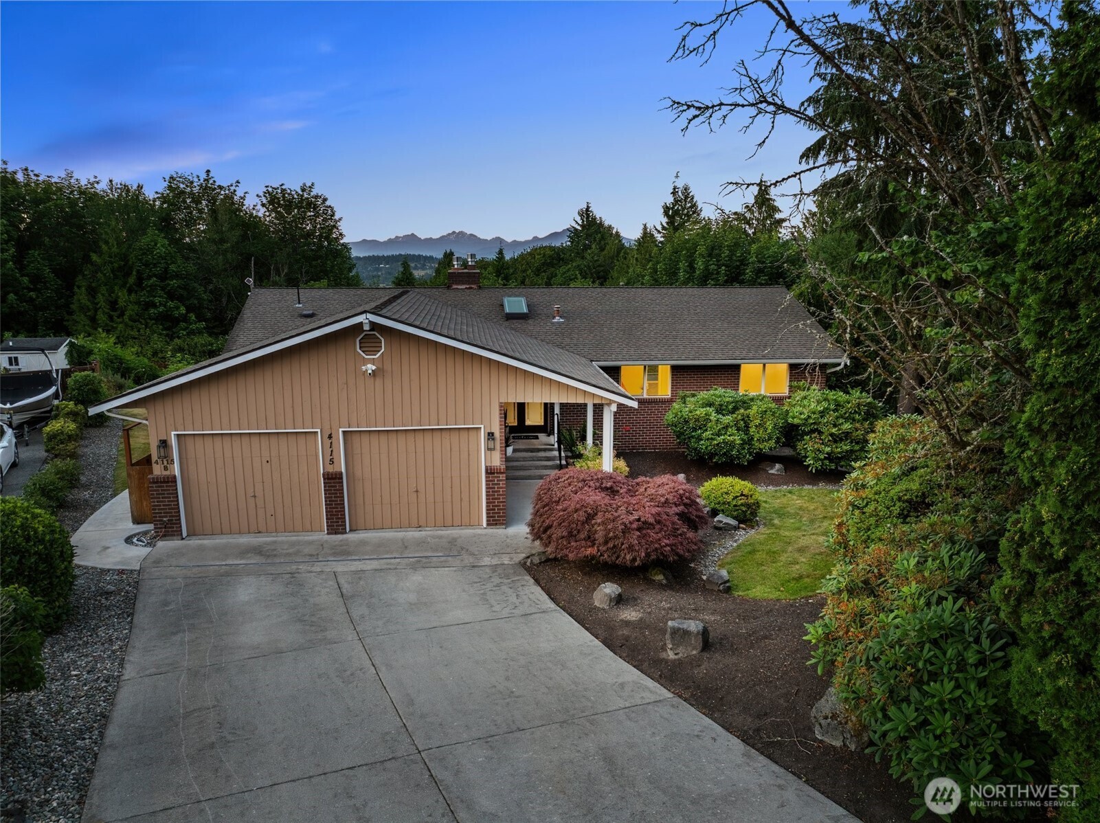 4115 105th Place Southeast Everett, WA 98208 - Photo 2 of 39 a view of a house with a yard plants and large tree