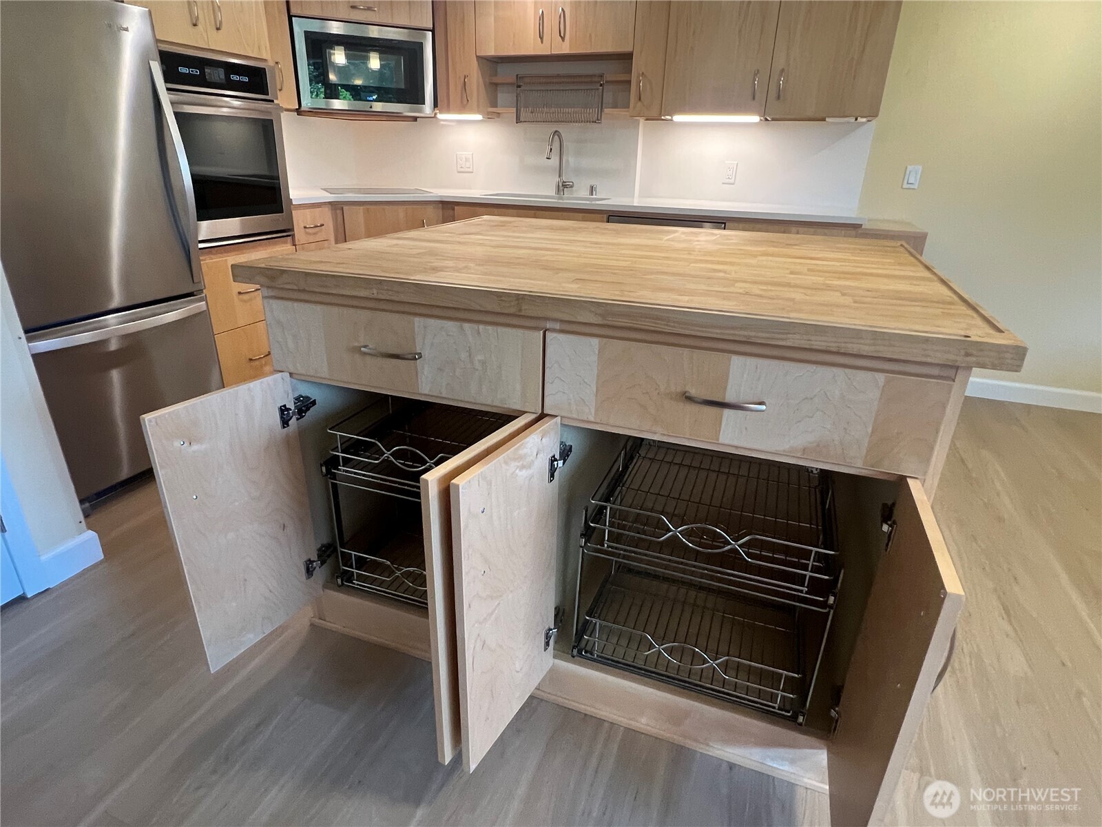 4115 105th Place Southeast Everett, WA 98208 - Photo 30 of 39 a kitchen with wooden floor and a stove top oven