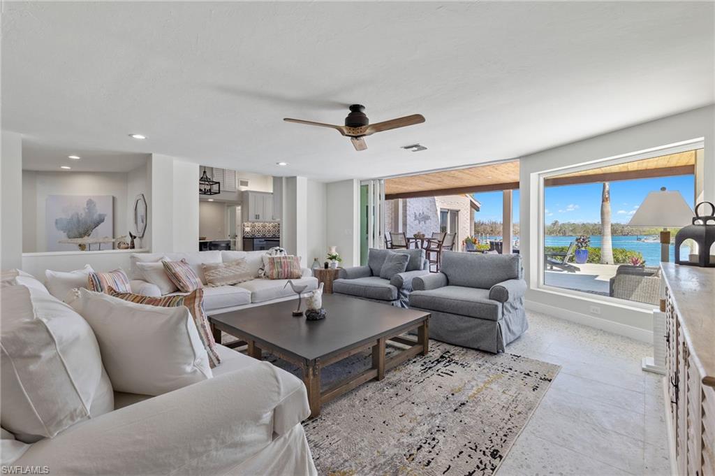 21521 Madera Road Fort Myers Beach, FL 33931 - Photo 15 of 45 a living room with furniture a rug and a floor to ceiling window
