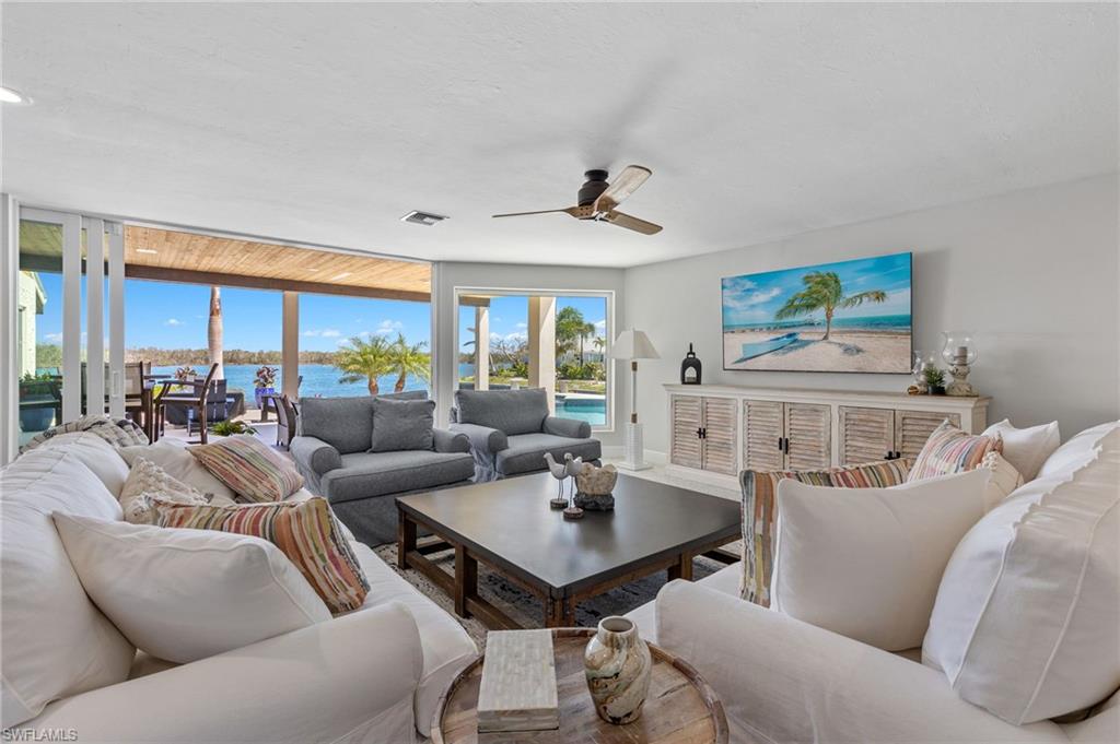 21521 Madera Road Fort Myers Beach, FL 33931 - Photo 16 of 45 a living room with furniture a table and a large window