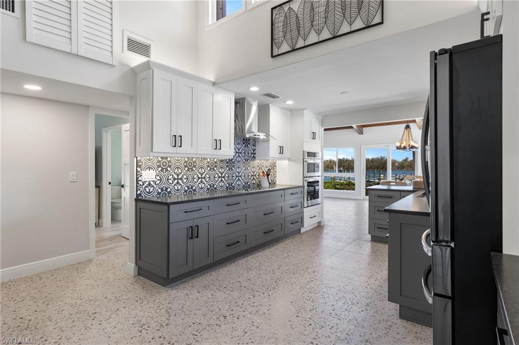 21521 Madera Road Fort Myers Beach, FL 33931 - Photo 22 of 45 a kitchen with stainless steel appliances granite countertop a refrigerator and a sink