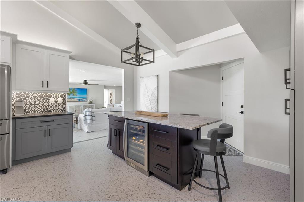 21521 Madera Road Fort Myers Beach, FL 33931 - Photo 24 of 45 a kitchen that has a lot of cabinets in it and wooden cabinets