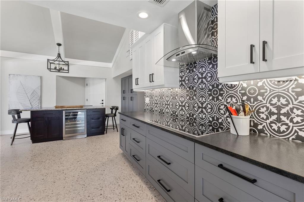 21521 Madera Road Fort Myers Beach, FL 33931 - Photo 25 of 45 a kitchen with stainless steel appliances granite countertop a stove a sink and a refrigerator