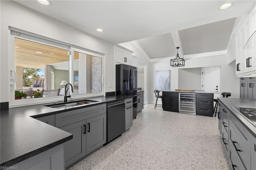 21521 Madera Road Fort Myers Beach, FL 33931 - Photo 26 of 45 a large kitchen with a large counter top appliances and cabinets