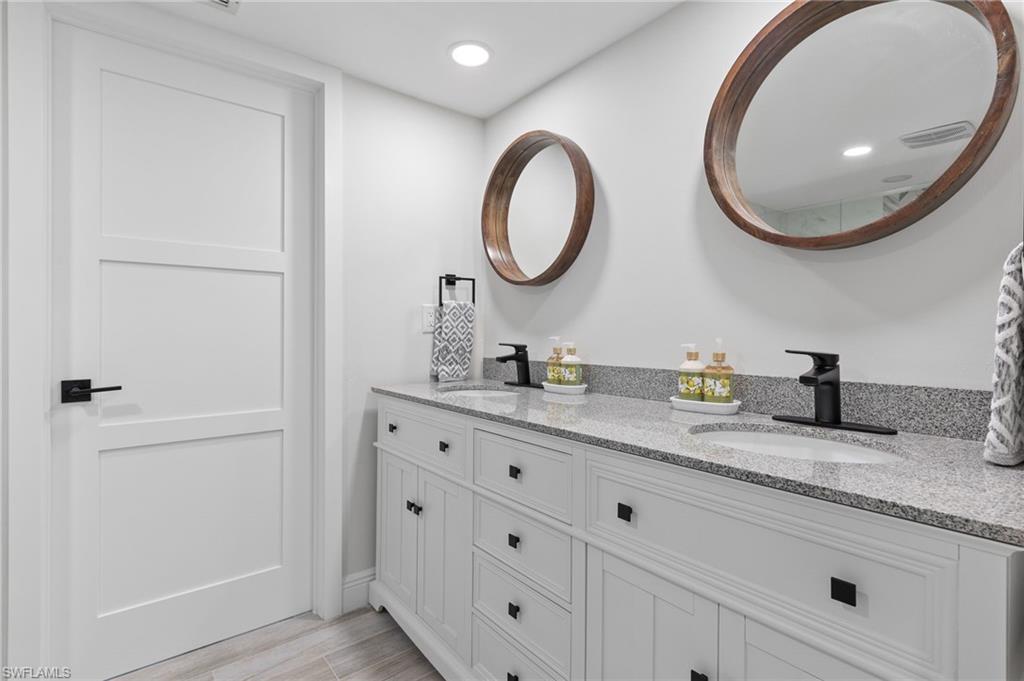 21521 Madera Road Fort Myers Beach, FL 33931 - Photo 30 of 45 a bathroom with a granite countertop double vanity sink and a mirror